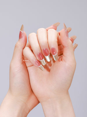 Nude and gold French tip oval press-on nails made from PMMA acrylic