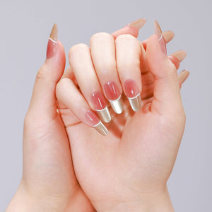 Nude and gold French tip oval press-on nails made from PMMA acrylic
