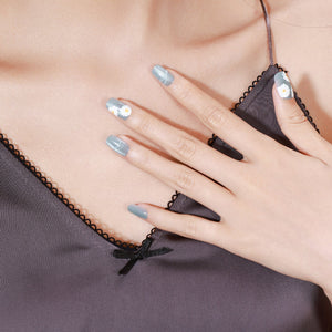 Hand wearing Daisy Dream medium square pastel daisy press-on nails with glossy gel finish