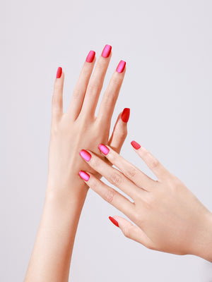 Close-up of Popstar Pink PMMA acrylic short square hot pink press-on nails