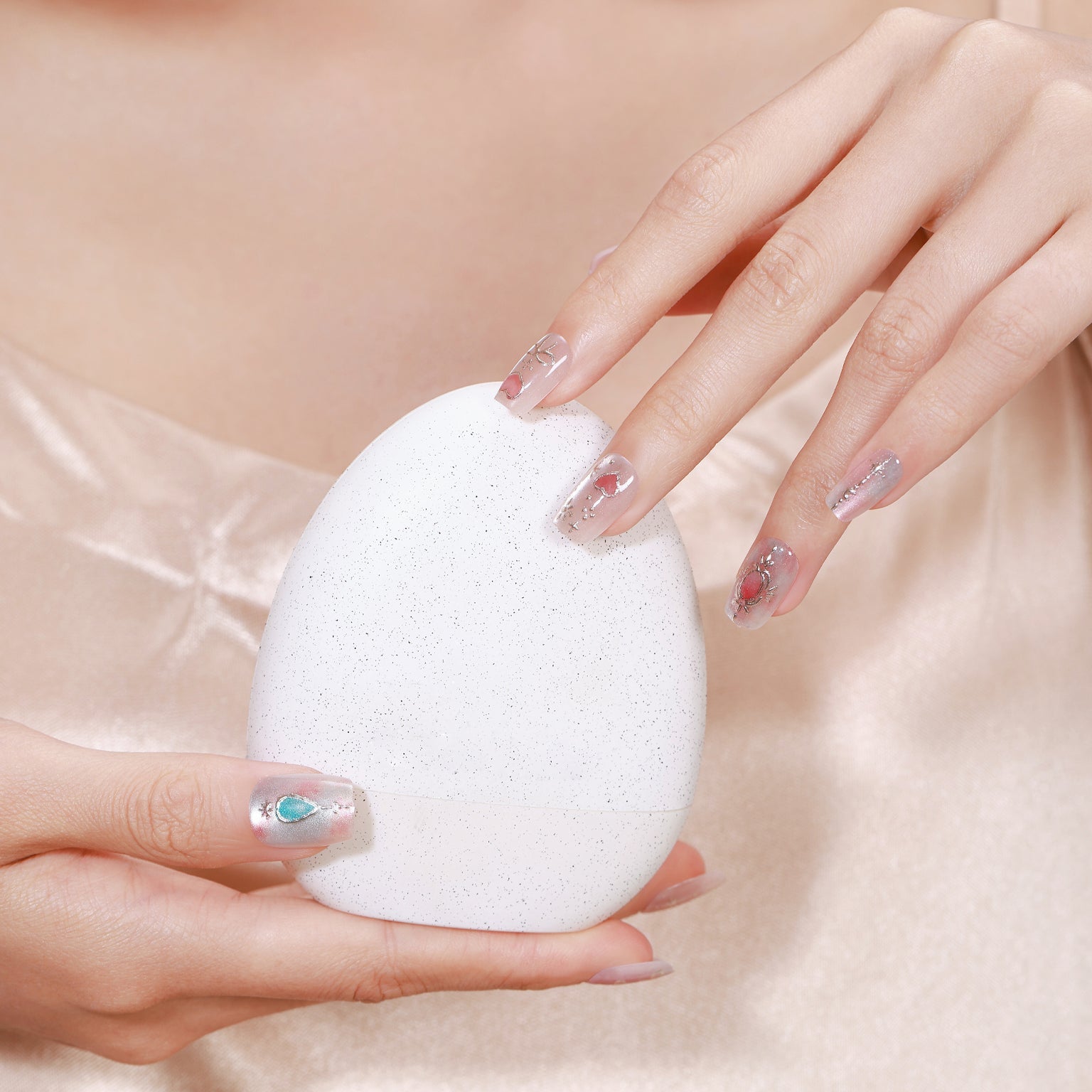 Hand wearing Blushing Belle soft pink press-on nails with glossy gel-style finish