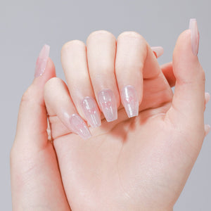 Hand wearing Cupid Glow pink heart glitter coffin press on nails with glossy finish