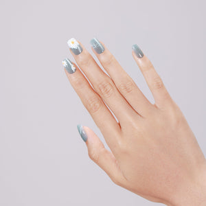 Hand wearing Daisy Dream medium square pastel daisy press-on nails with glossy gel finish