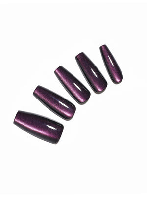 Hand wearing Eggplant dark purple long coffin press on nails with glossy finish