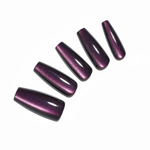 Hand wearing Eggplant dark purple long coffin press on nails with glossy finish