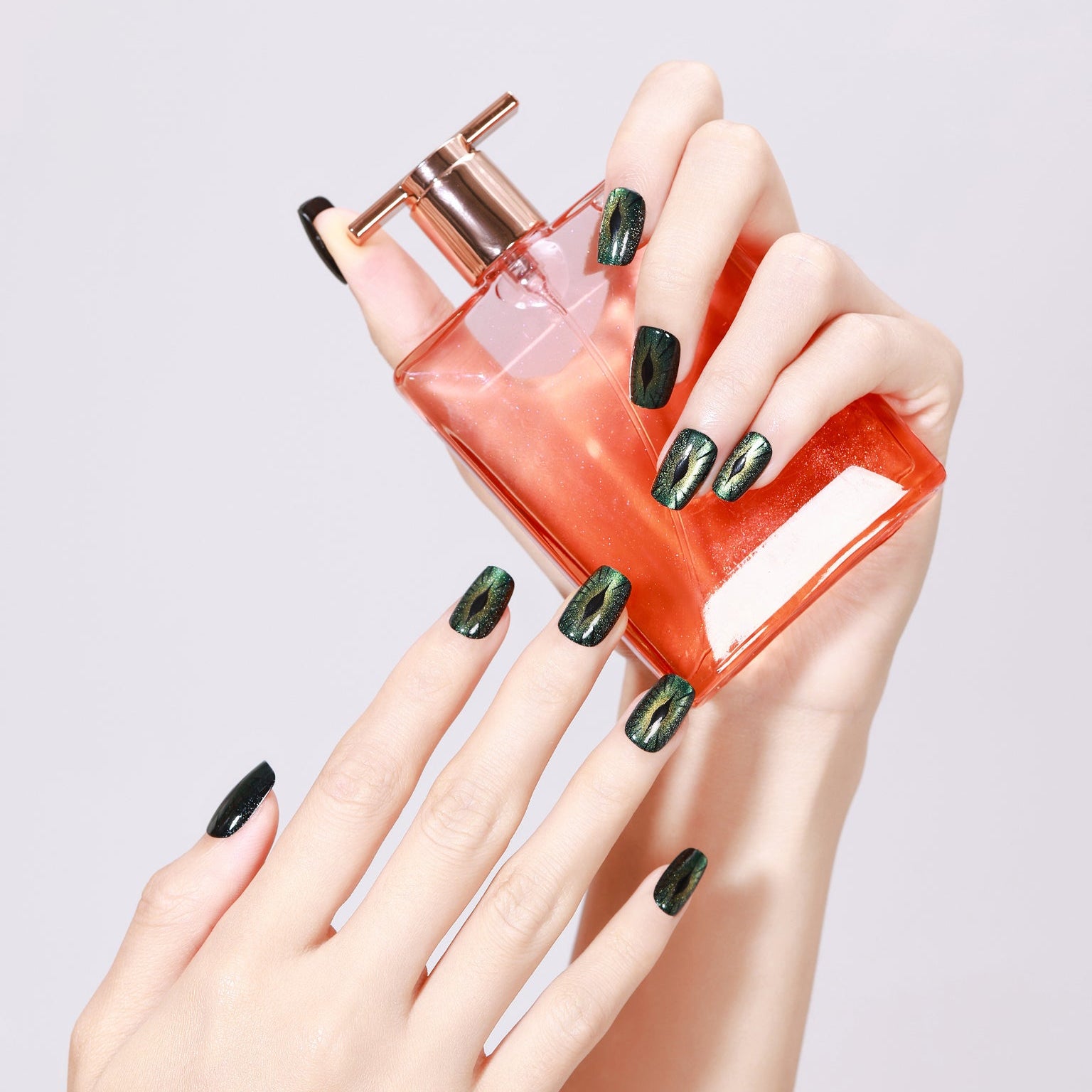 Hand wearing Evil Eyes short square evil eye nails with glossy gel finish