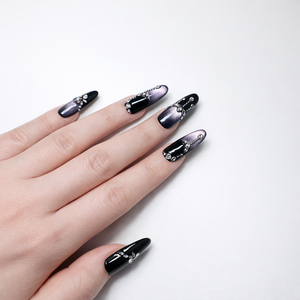 black and metallic purple almond press-on nails with silver rhinestone bow and chain details