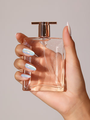 Hand wearing Crystal Fall iridescent holographic press on nails in a short to medium square shape