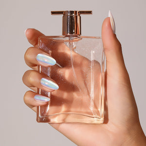 Hand wearing Crystal Fall iridescent holographic press on nails in a short to medium square shape