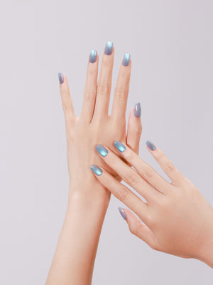 Close-up of Dragon Eyes PMMA acrylic short square teal press-on nails with pearly shine