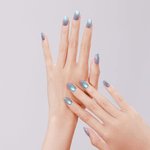 Close-up of Dragon Eyes PMMA acrylic short square teal press-on nails with pearly shine