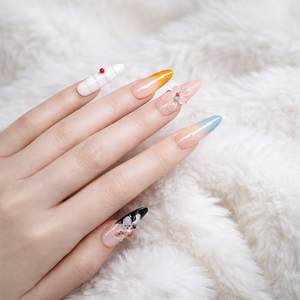 Multi color long almond press on nails with pastel ombre tips, orange French tip, white accent nail and 3D flower nail art on faux fur background