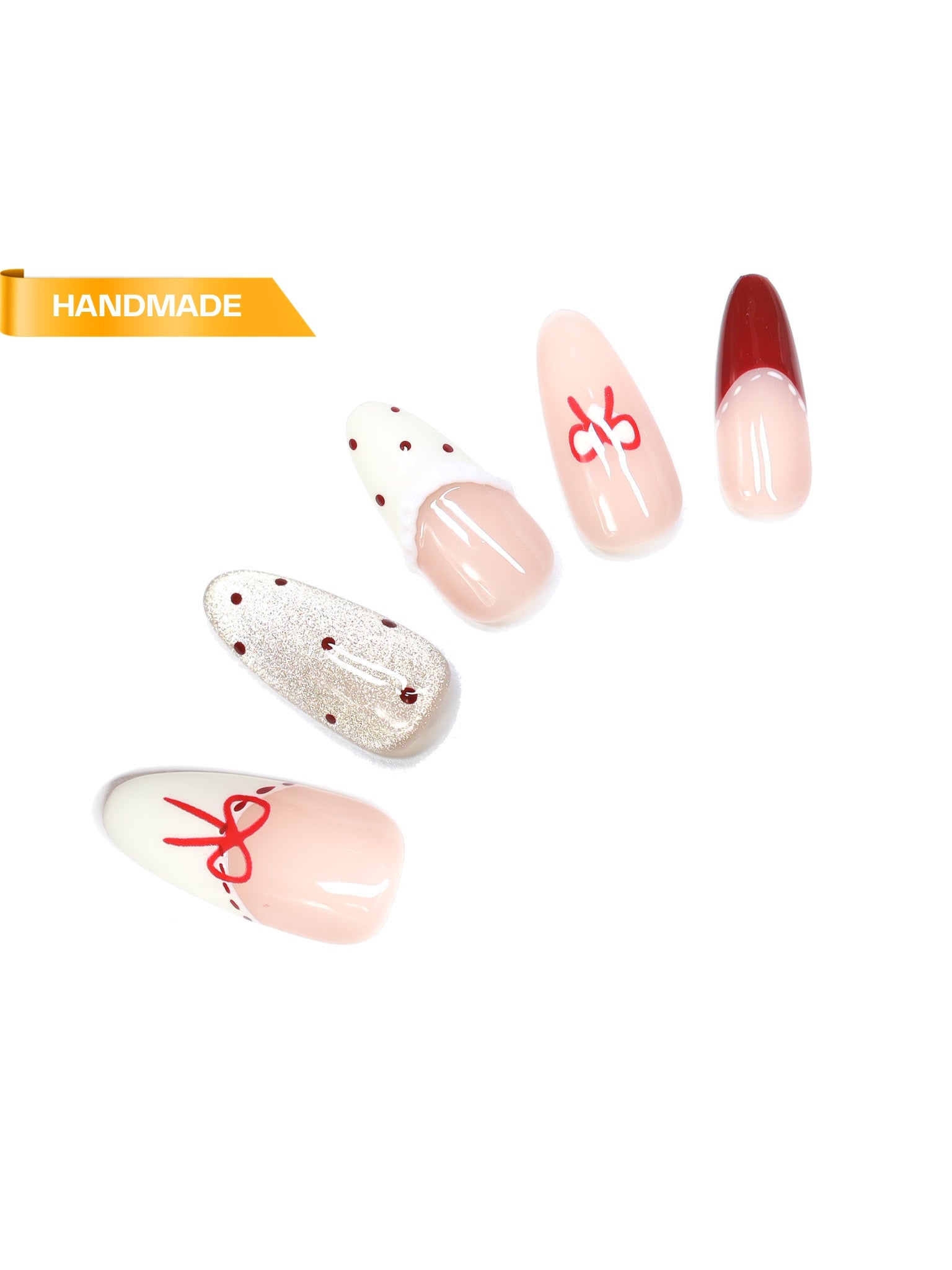 Handmade almond press-on nails in nude ombré with red bow detailing, red French tips, and glitter accent nail on white background