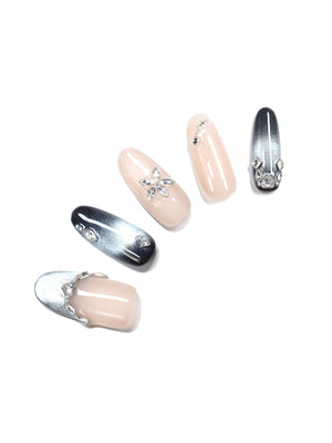 Handmade oval nude press-on nails with silver chrome ombre and rhinestone accents