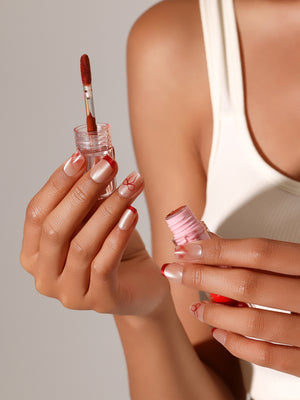 Red French tip press on nails with bow nail art on nude shimmer base