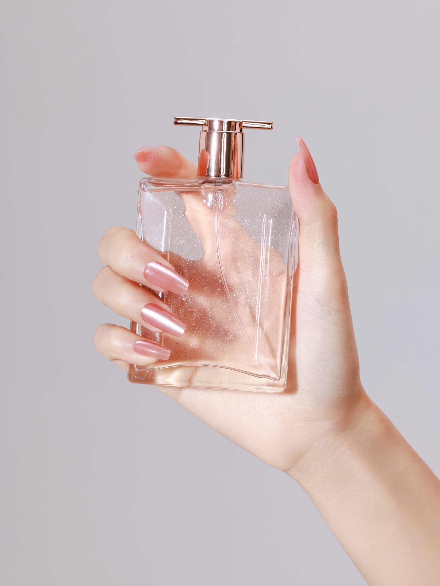 Hand wearing Pink Blush long coffin rose pink chrome press-on nails