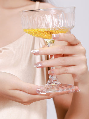 Hand wearing Snowy Wishes white winter glitter press on nails for holiday look