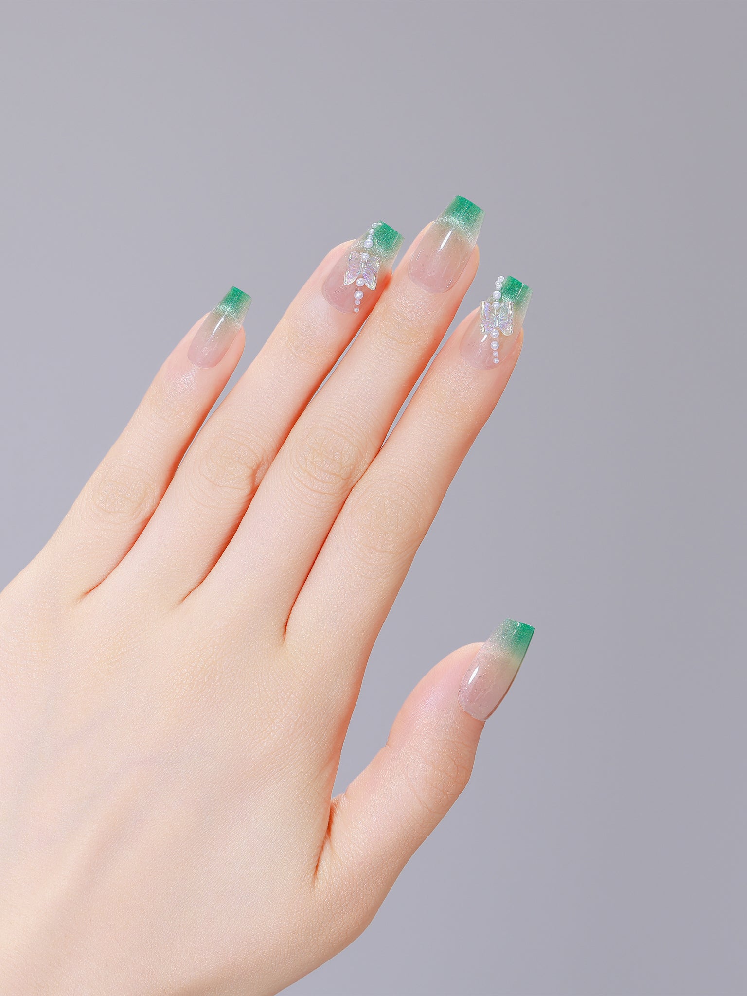 Both hands showing Garden Grace long coffin green French tip PMMA acrylic press-on nails