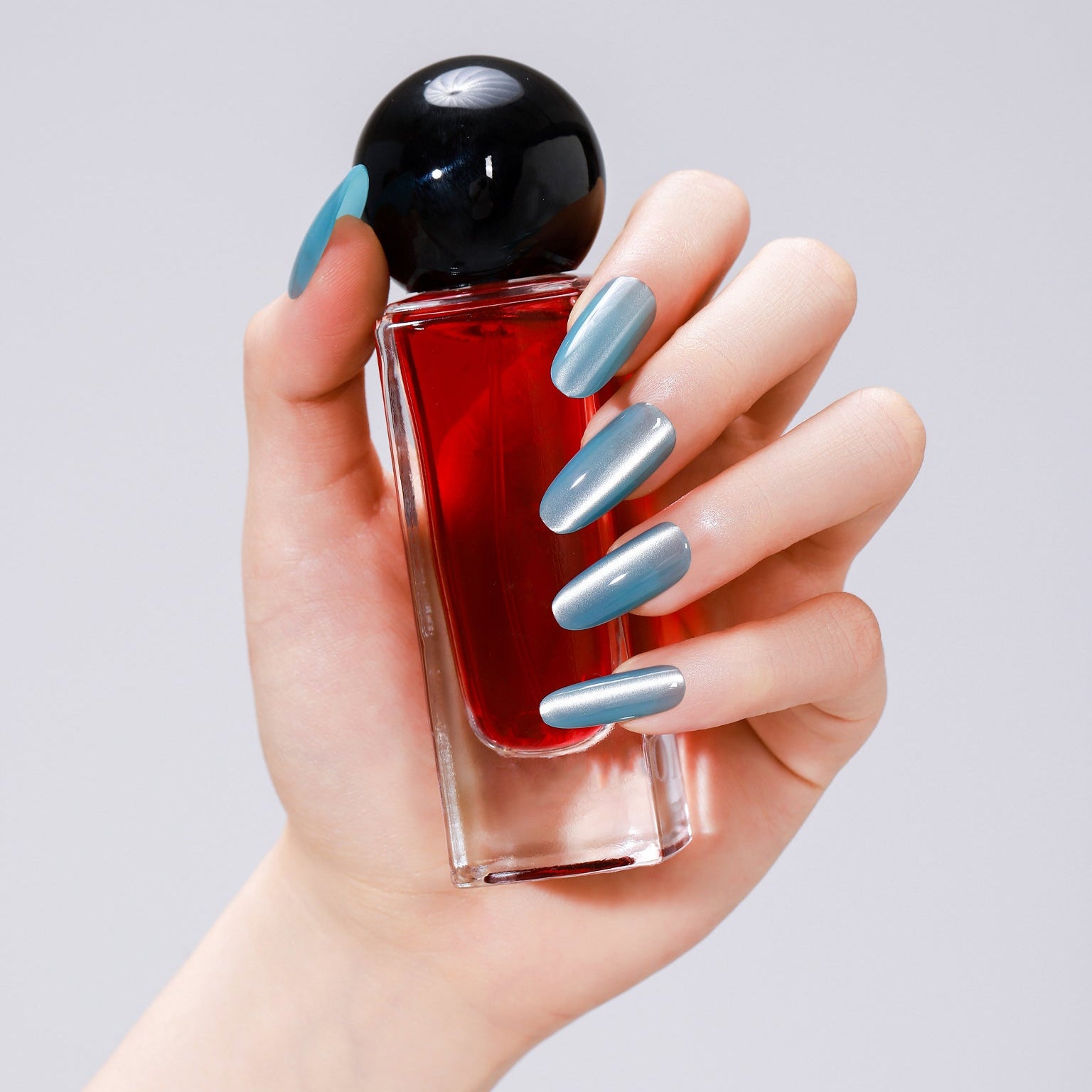 Long oval deep blue cat eye press-on nails with magnetic shimmer gel finish