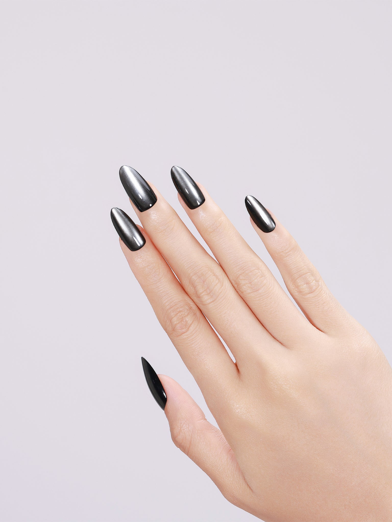 Close-up Noir Eclipse long almond gunmetal black press-on nails mirror chrome finish