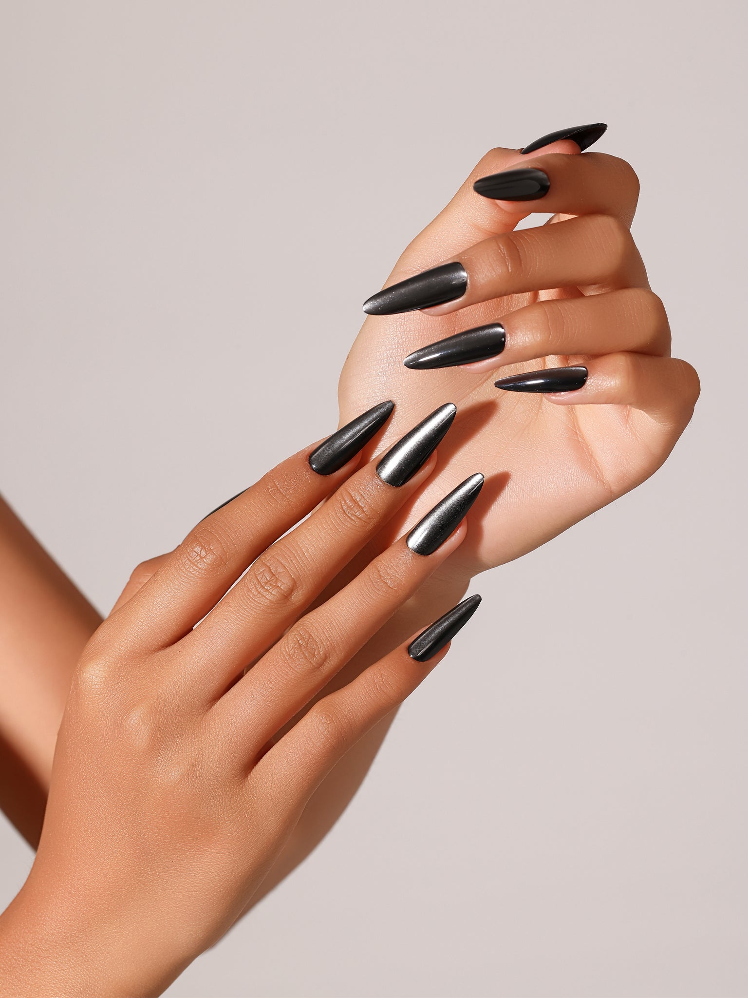 Close-up Witching Hour black chrome stiletto press-on nails high gloss metallic finish
