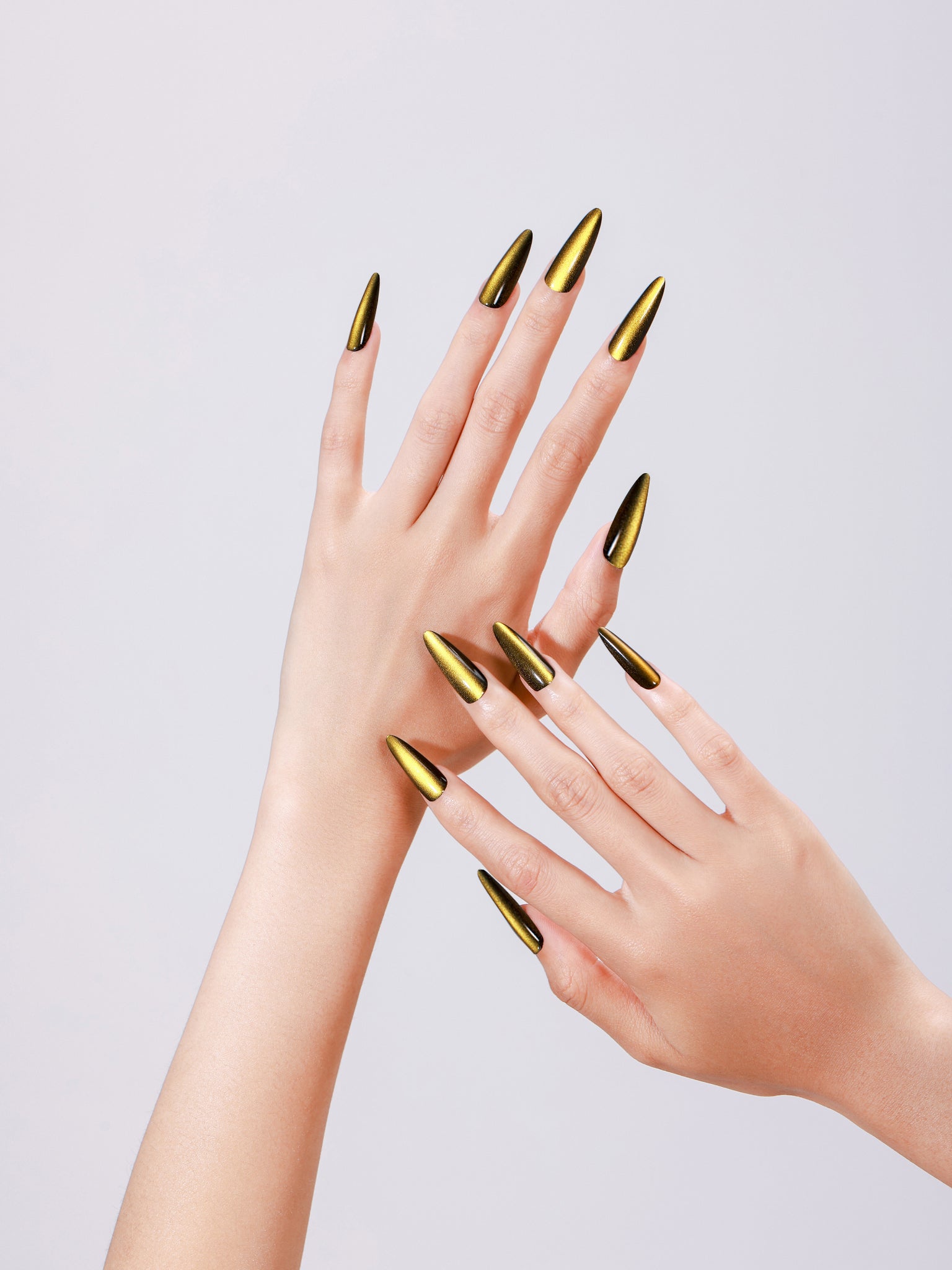 Hand wearing Sunlit Matcha long stiletto gold green chrome press-on nails glossy metallic finish