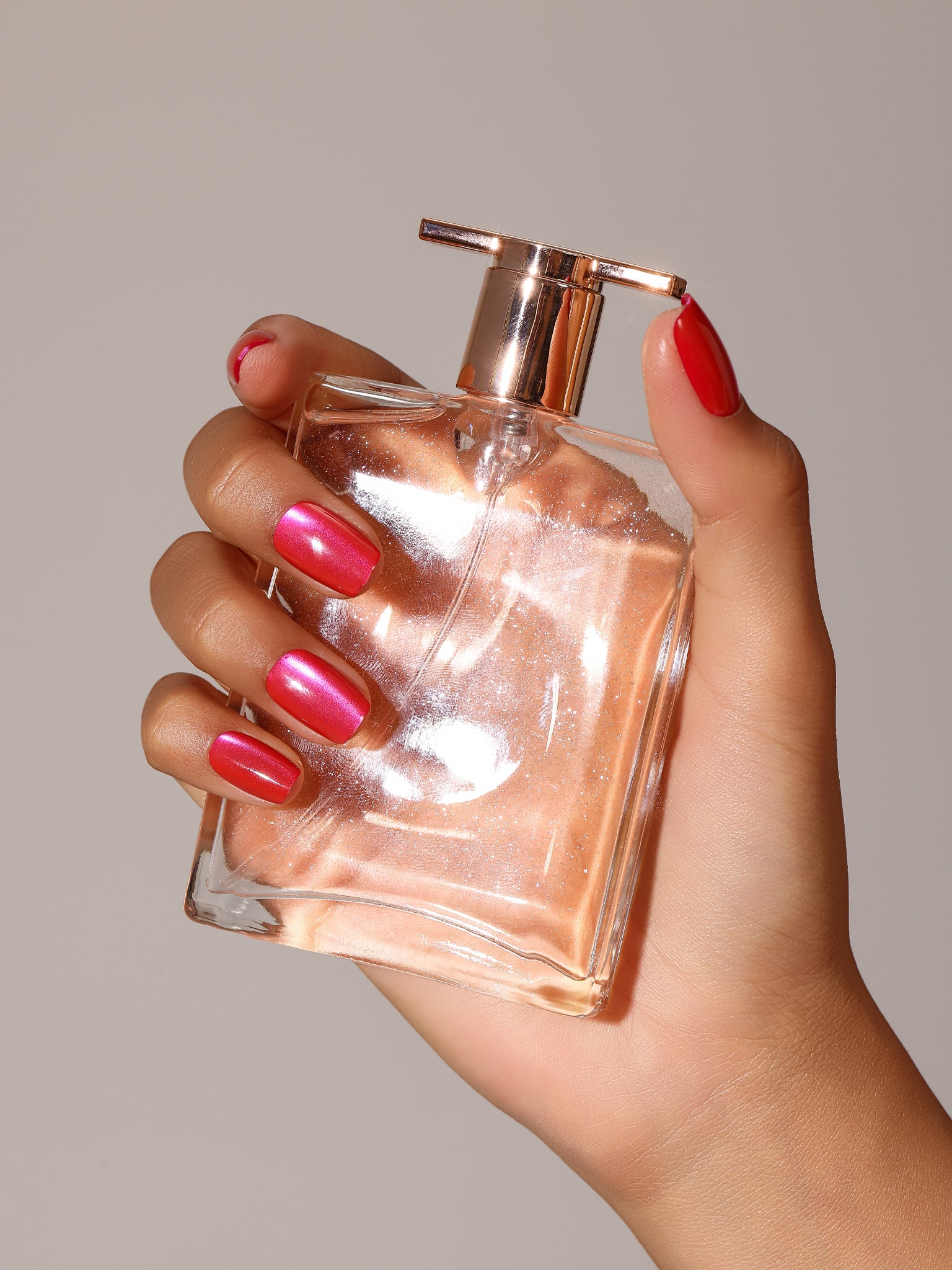 Close-up Hot Pink Rush magenta cat eye shimmer press-on nails square shape with coral red accents