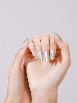 Hand wearing Spring Garden long almond mint green chrome press-on nails with white floral accent