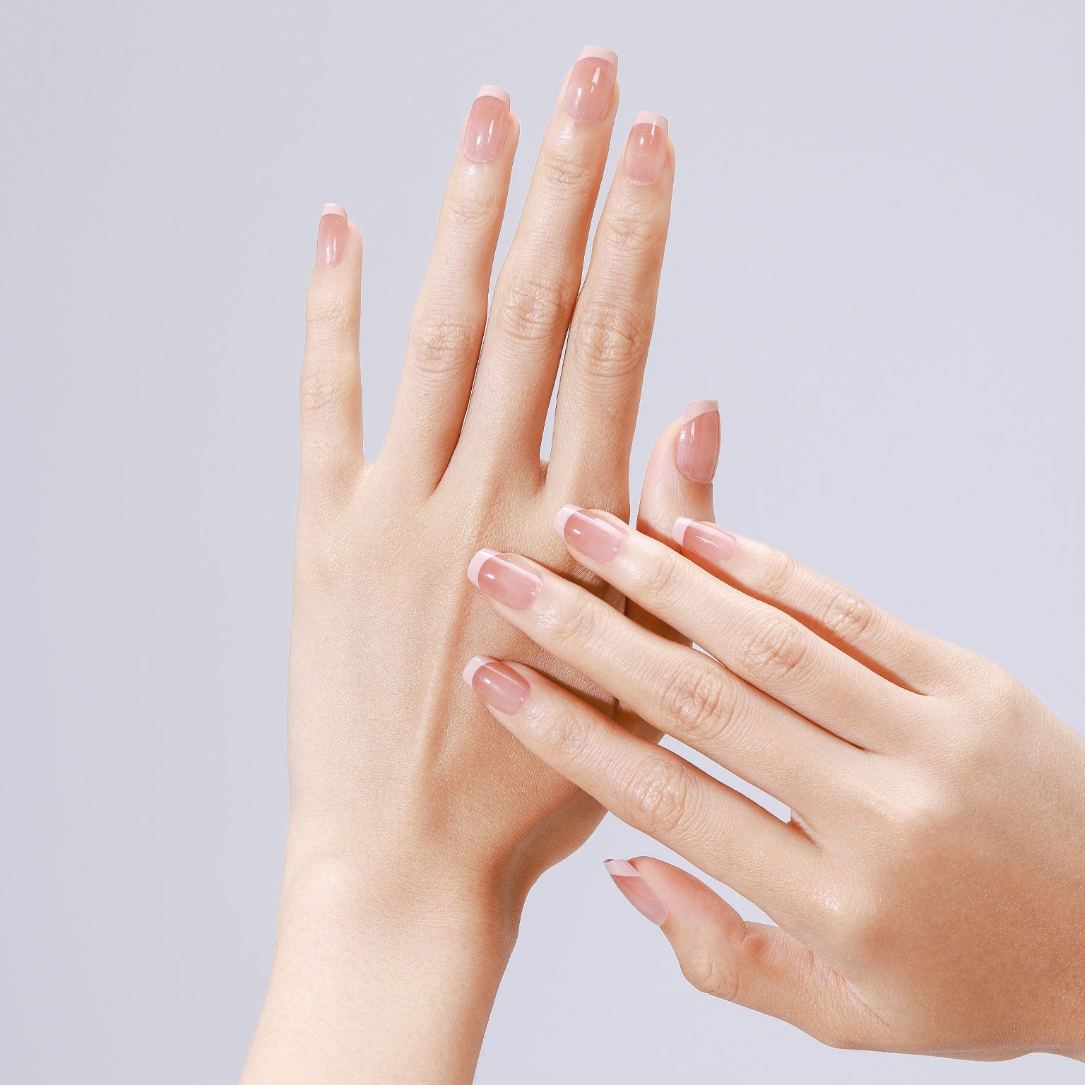 Closeup of Nude Illusion nude ombre acrylic press-on nails in short square shape