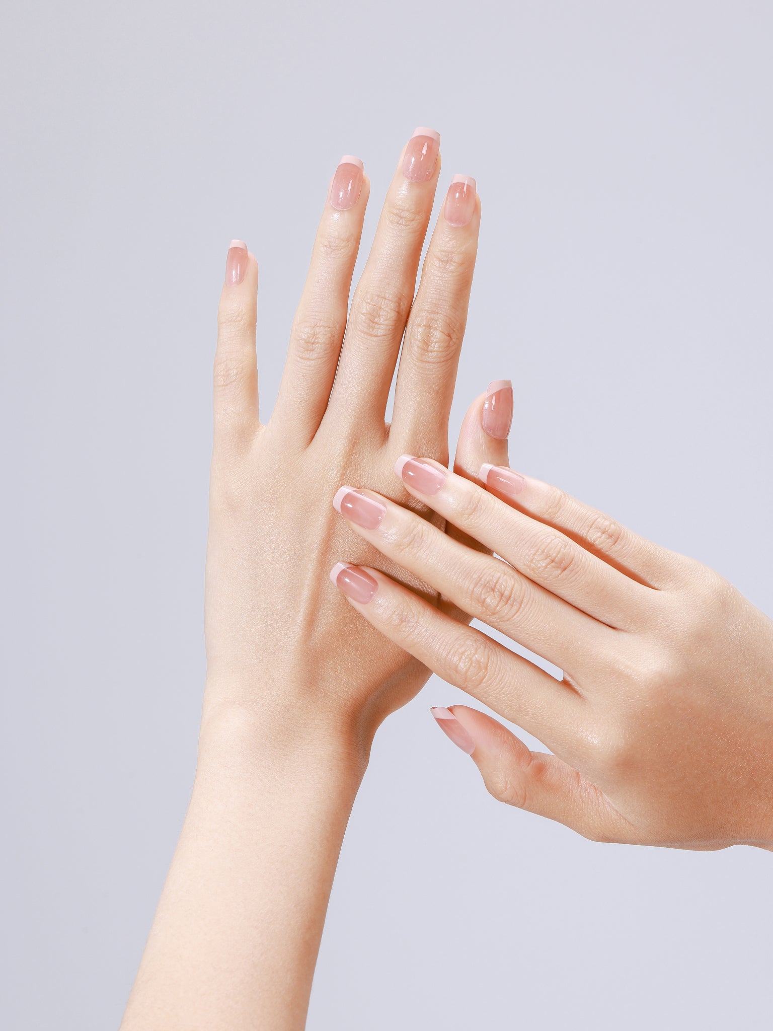 Closeup of Nude Illusion nude ombre acrylic press-on nails in short square shape