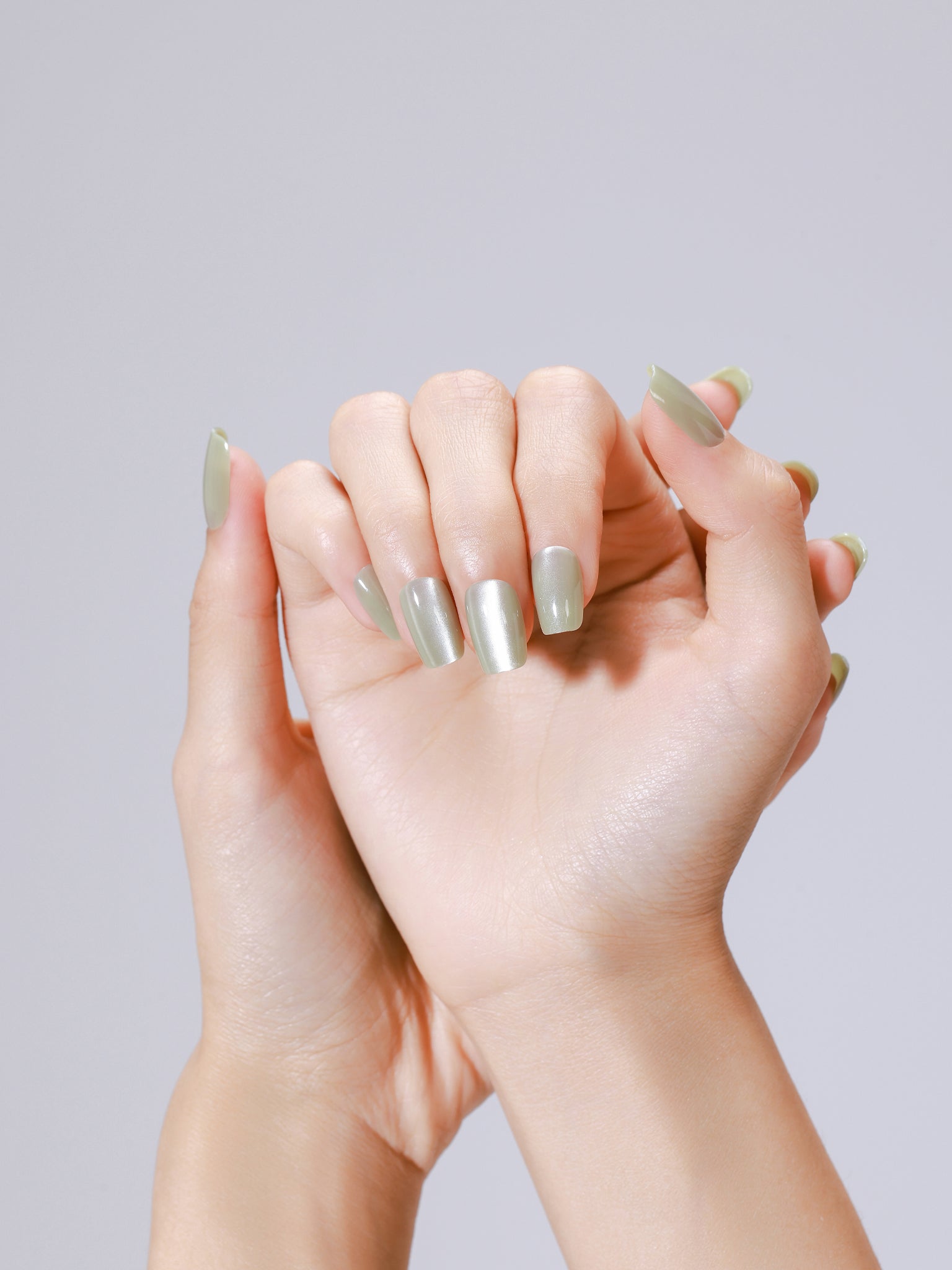 Applying Matcha Latte matcha green press on nails at home using glue and adhesive tabs