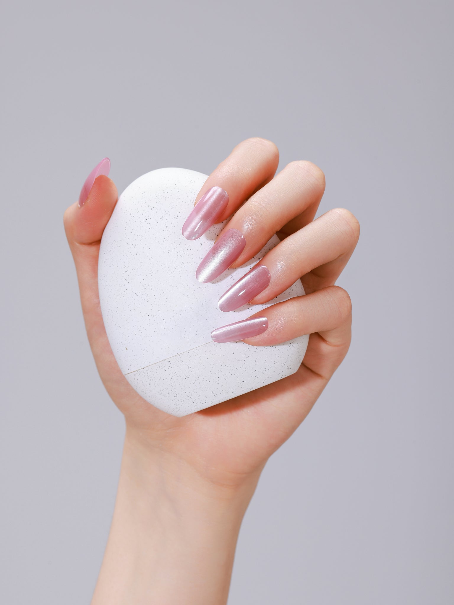 Close-up of Pink Cloud long oval pink acrylic press-on nails with salon-grade gel shine