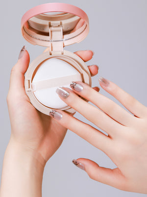 Hand wearing Cocoa Spots square press-on nails with speckled brown design