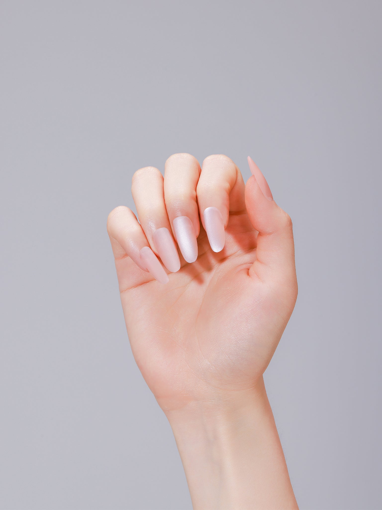 Close-up of Nude Blossom PMMA acrylic long oval nude press-on nails