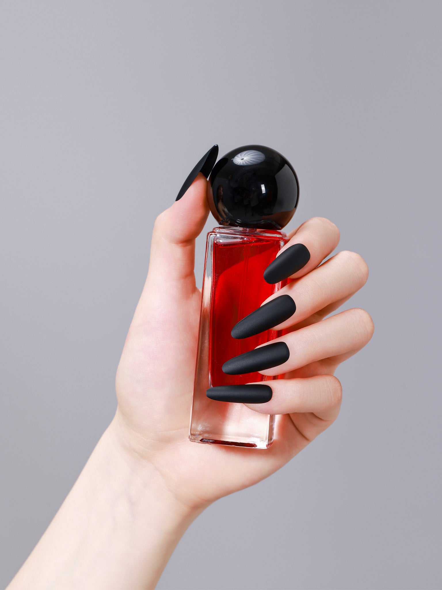 Close-up of long oval matte black PMMA acrylic press-on nails from ShadePax