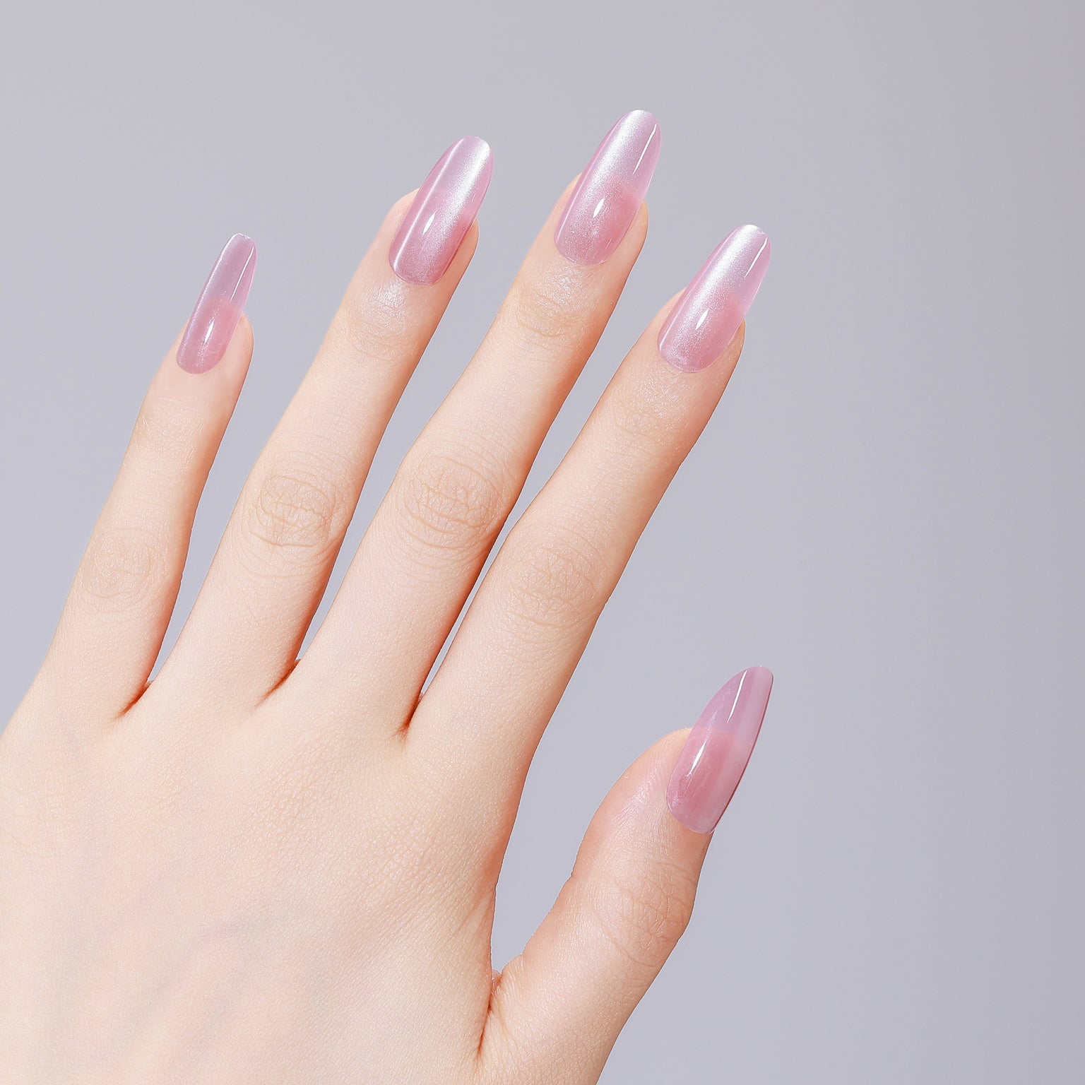 Close-up of Pink Cloud long oval pink acrylic press-on nails with salon-grade gel shine