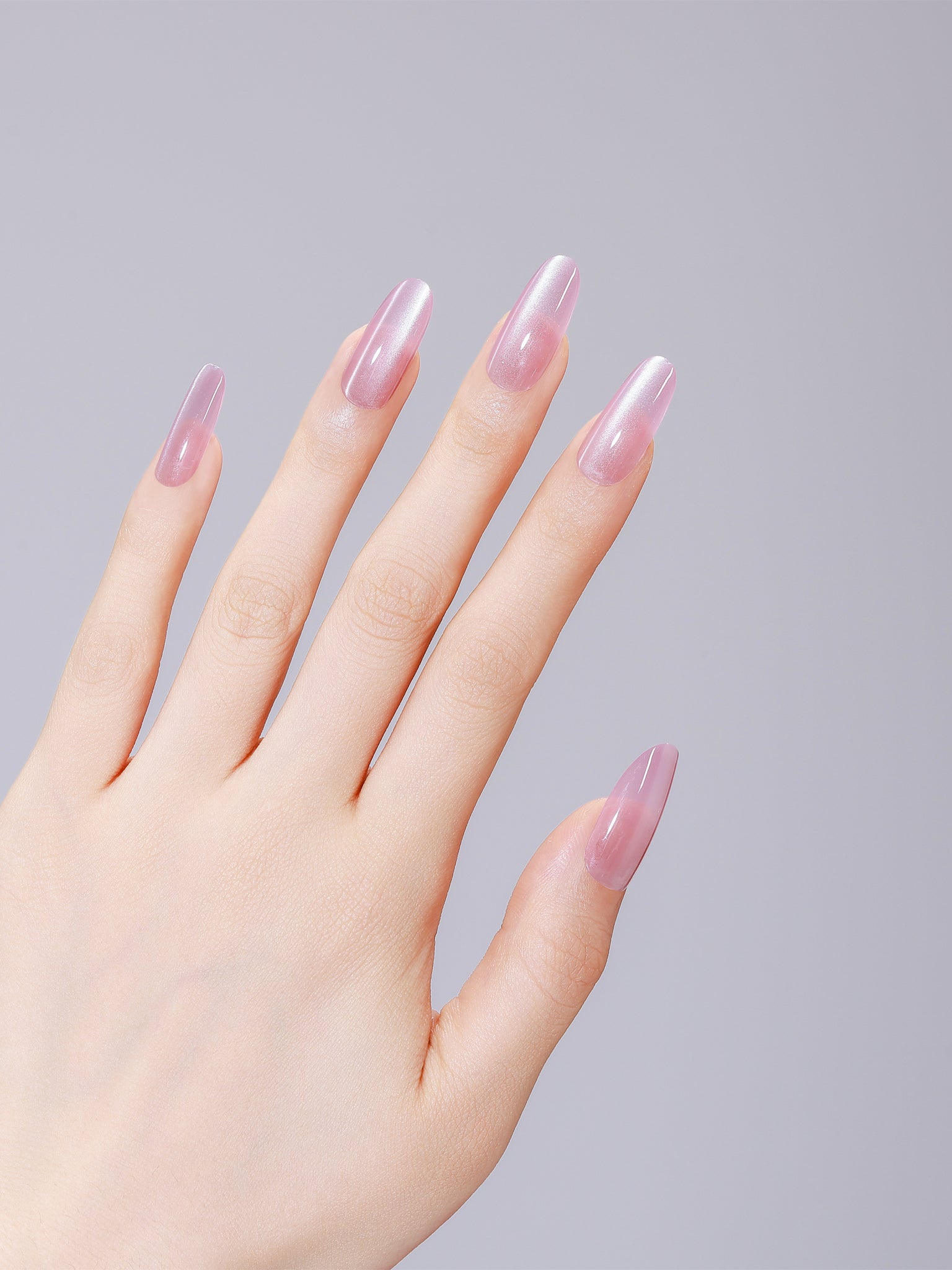 Close-up of Pink Cloud long oval pink acrylic press-on nails with salon-grade gel shine