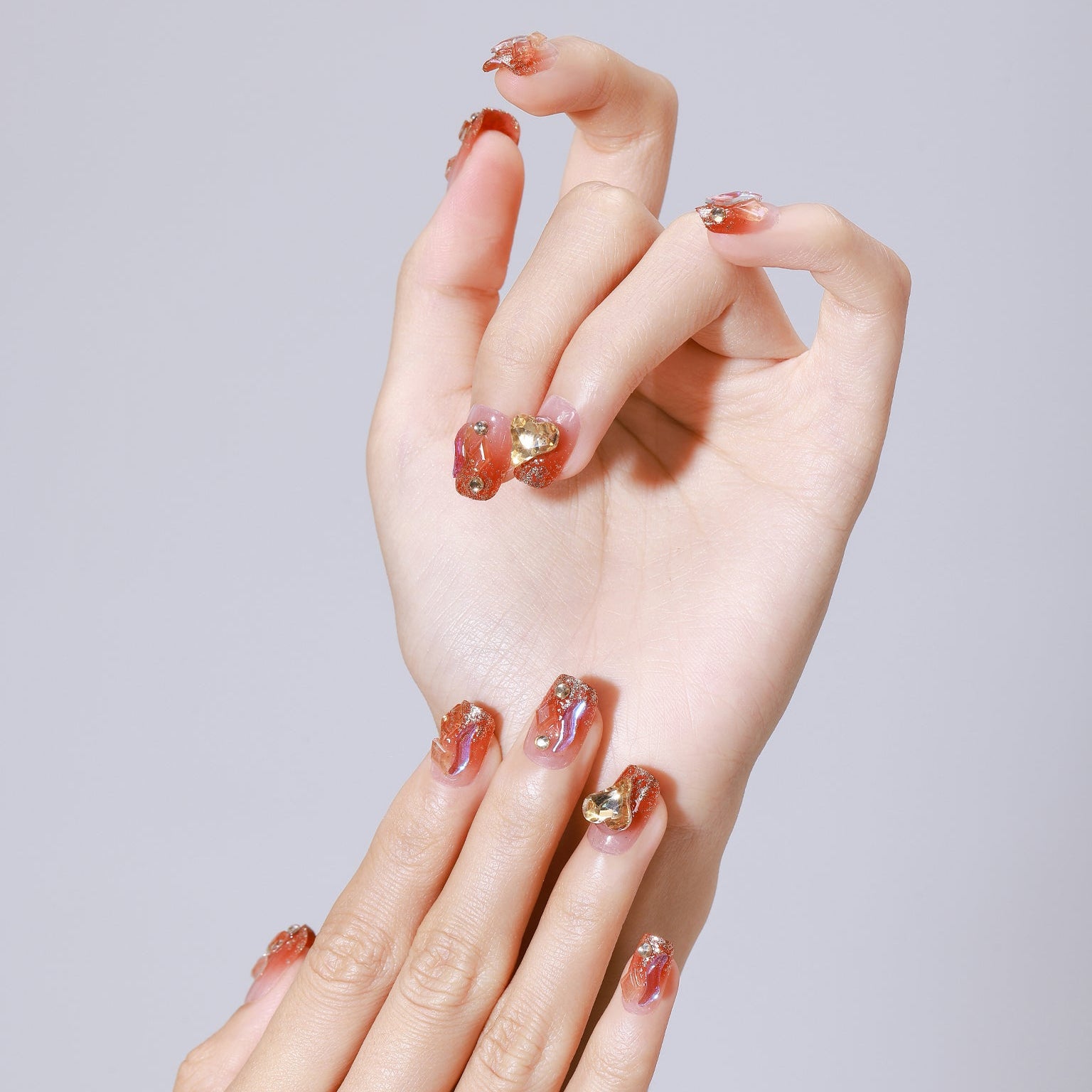 Hand wearing Fire and Flame red orange flame press-on nails with glossy finish