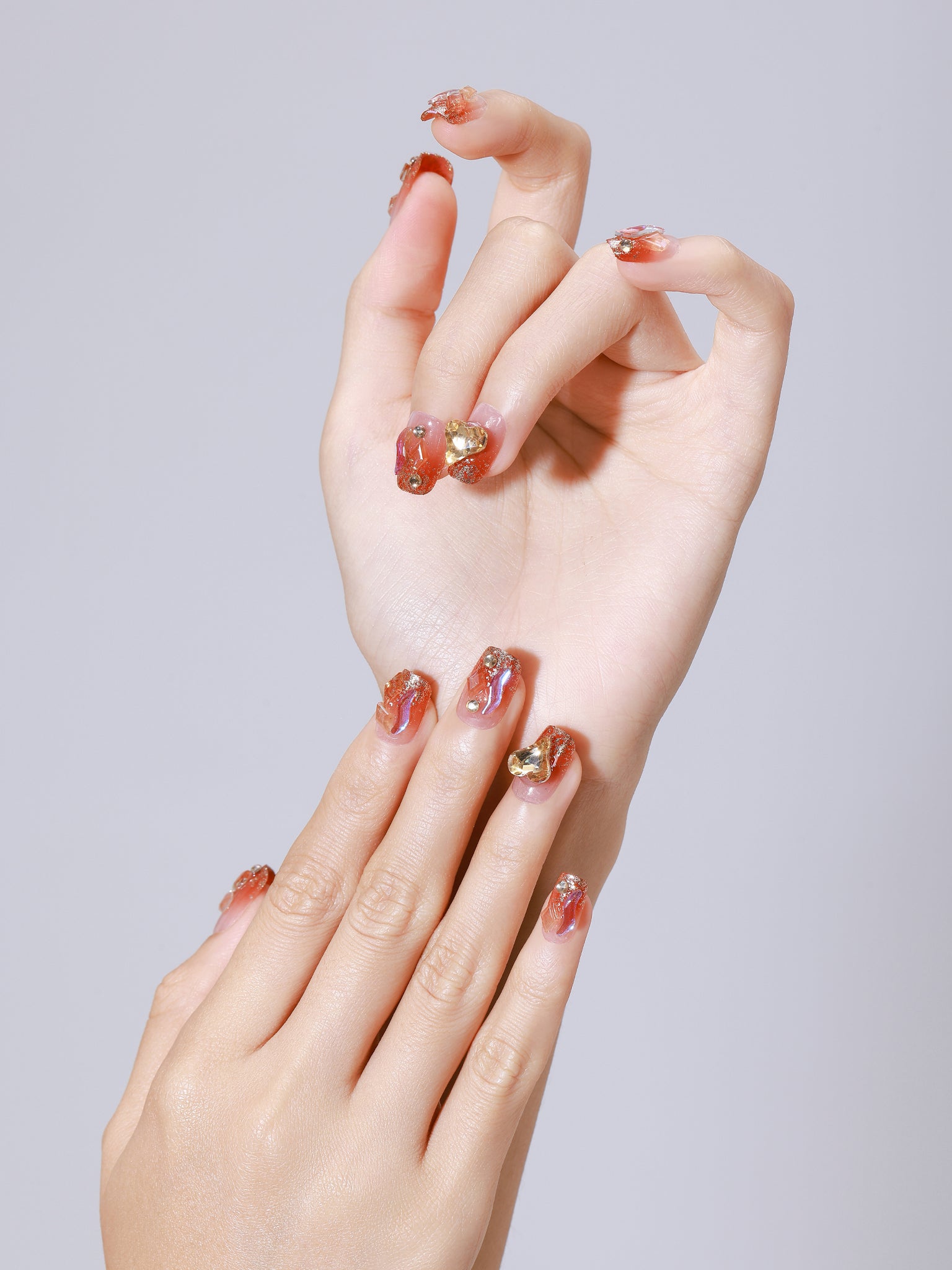 Hand wearing Fire and Flame red orange flame press-on nails with glossy finish