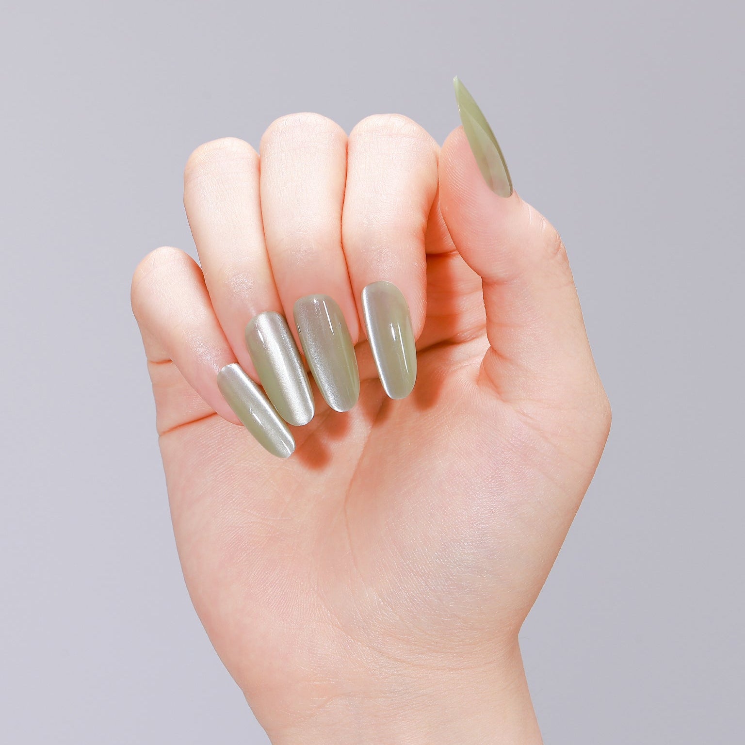Close-up of jade green jelly cat eye press-on nails made from PMMA acrylic
