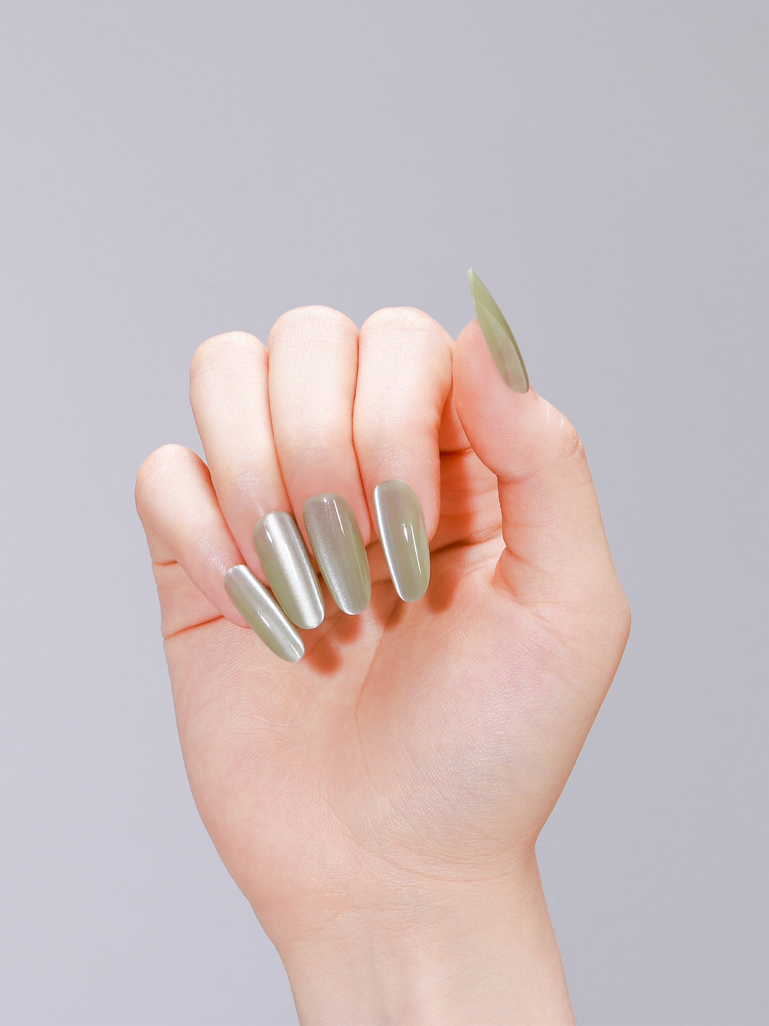 Close-up of jade green jelly cat eye press-on nails made from PMMA acrylic