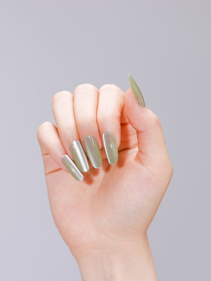 Close-up of jade green jelly cat eye press-on nails made from PMMA acrylic