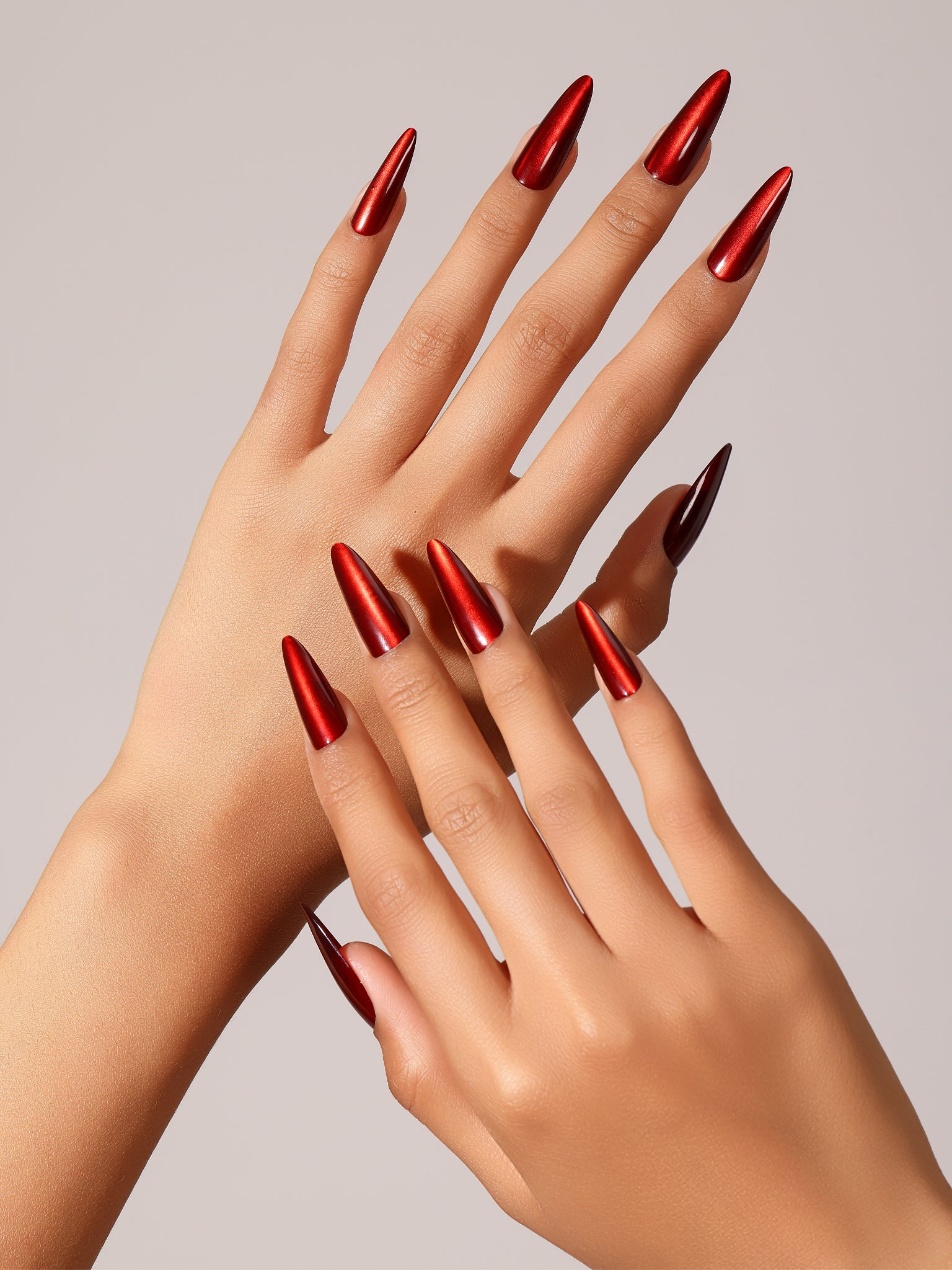 Hand wearing Ruby Rush classic ruby red almond press on nails with glossy finish