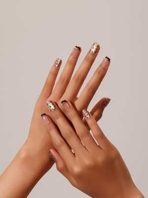 Hand wearing Cocoa Leopard short square nude nails with cocoa micro French tips and leopard accent nails
