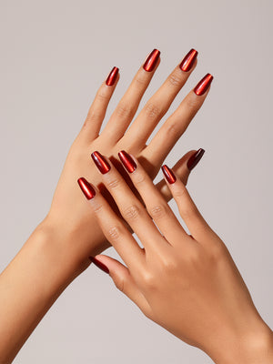 Hand wearing Flame Game metallic red coffin press on nails for bold night-out look