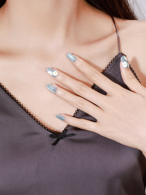 Hand wearing Daisy Dream medium square pastel daisy press-on nails with glossy gel finish