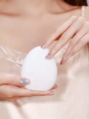 Hand wearing Blushing Belle soft pink press-on nails with glossy gel-style finish