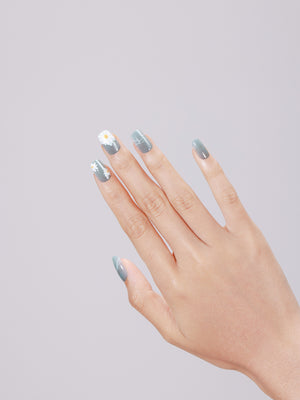 Hand wearing Daisy Dream medium square pastel daisy press-on nails with glossy gel finish