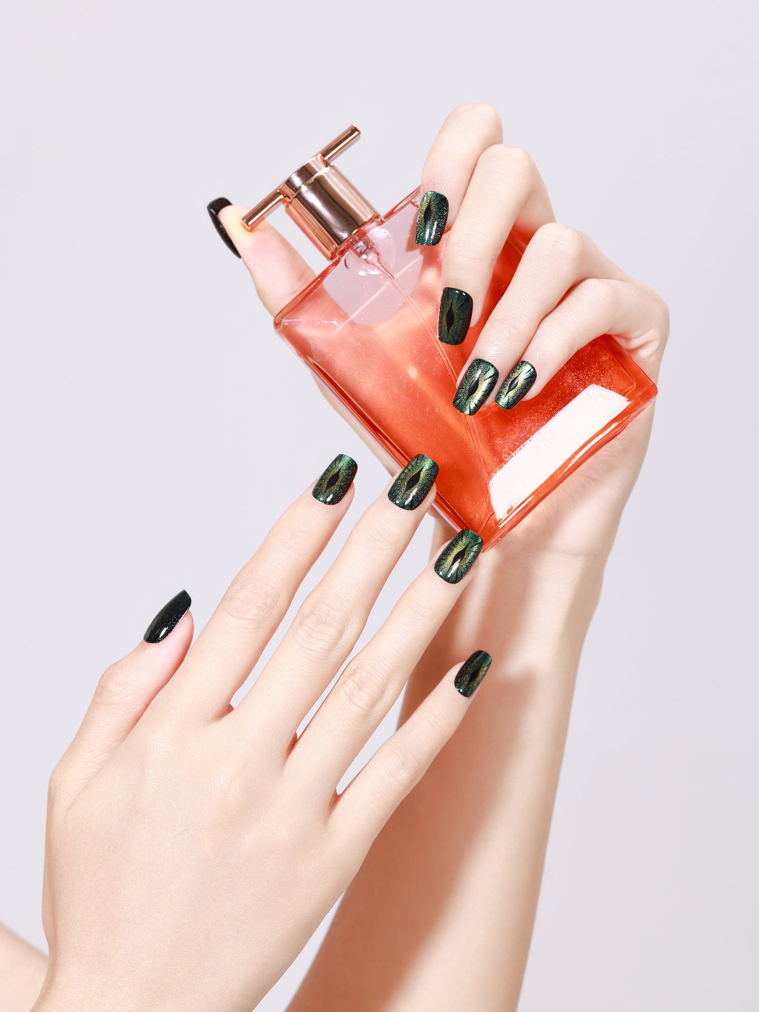 Hand wearing Evil Eyes short square evil eye nails with glossy gel finish