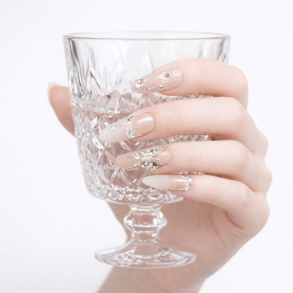 Handmade bridal French press on nails with nude ivory tips, pearl embellishments, and rhinestone butterfly ring nail
